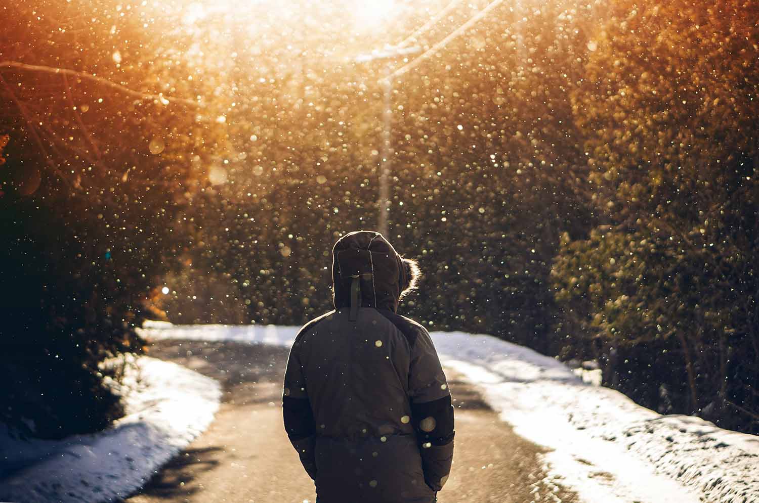 a person standing on a road in the snow